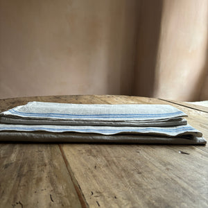 French Vintage Fabric Panels with blue stripes hanging  in a cottage window by Penlen